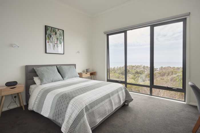 Bedroom with Large Windows and Beach Views